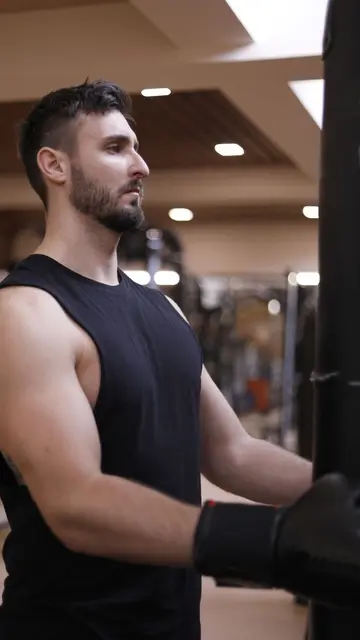 Placement still — Man focused on workout in gym, showcasing strength and determination.